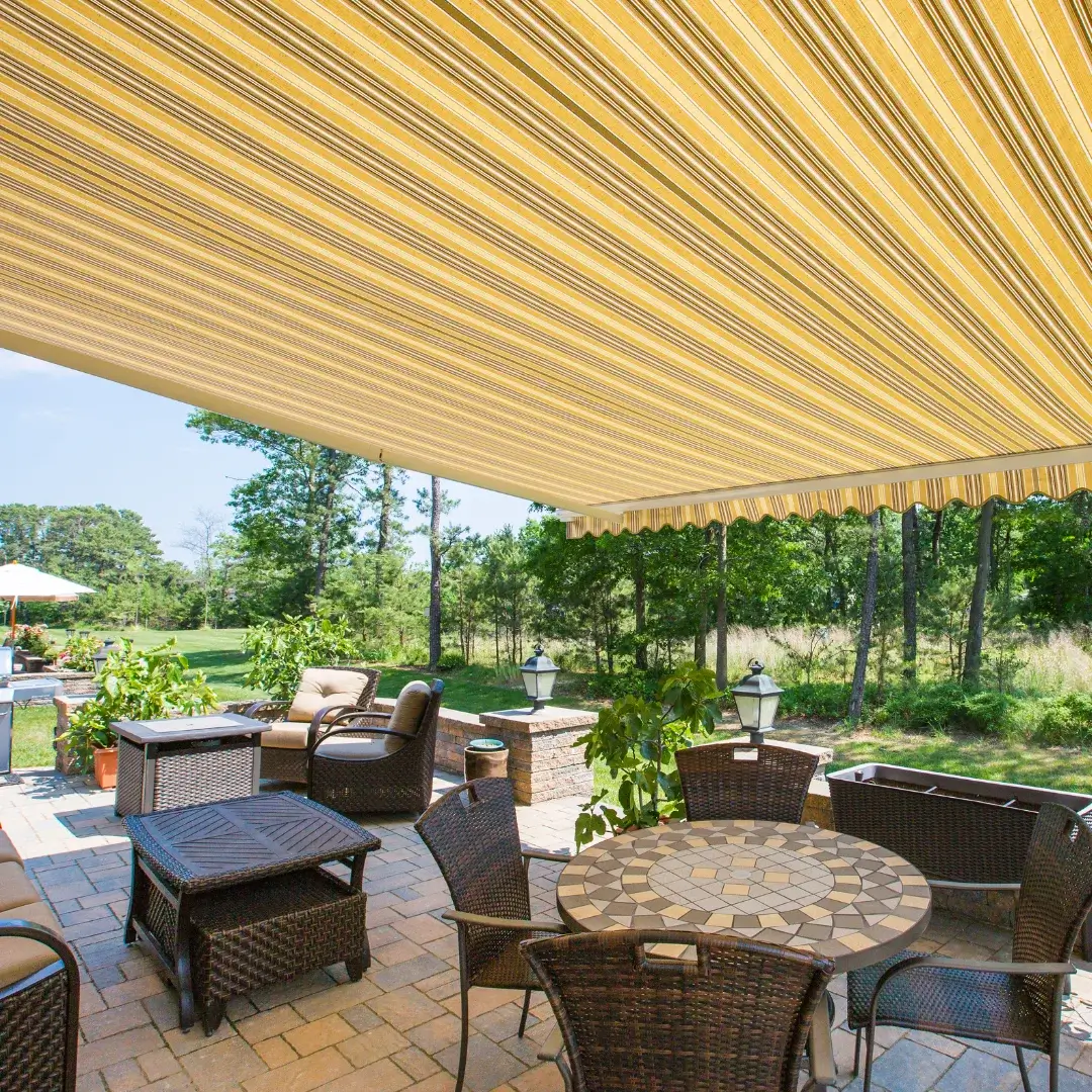 yellow striped retractable awning over an outdoor seating area
