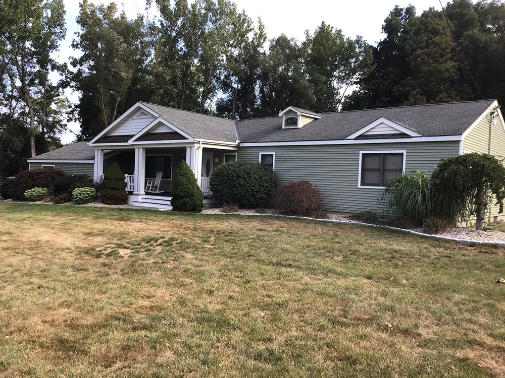 green vinyl siding installed on ranch home
