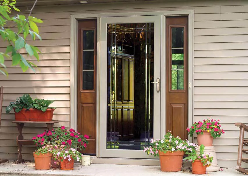 tan storm door on a tan house with wood side panels